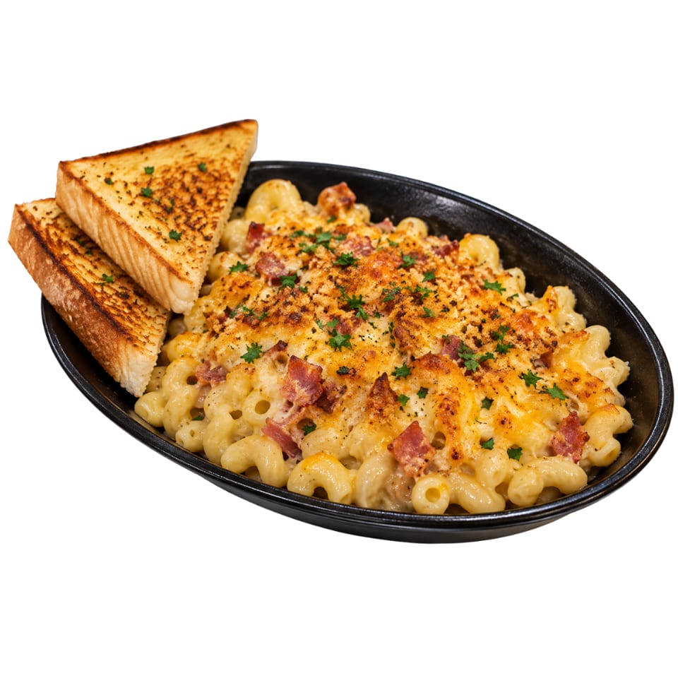 Creamy baked macaroni and cheese topped with bacon, breadcrumbs, and parsley, served with toasted garlic bread in a black dish.